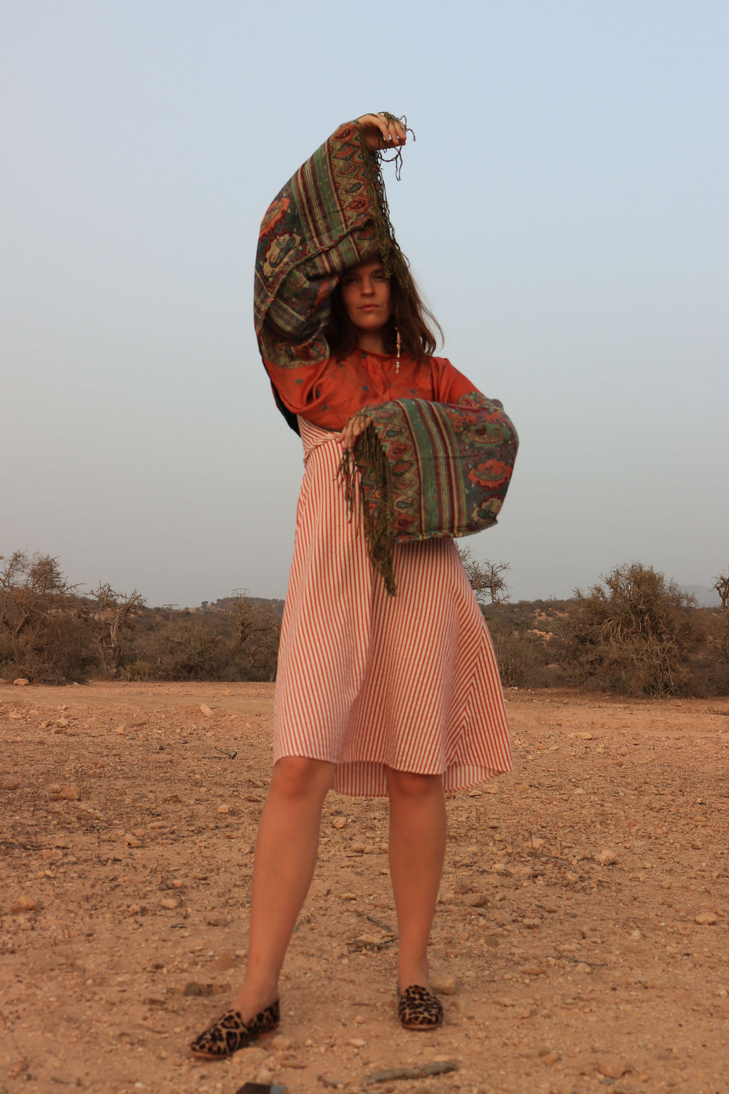 woman in a dessert type setting showing, wearing gawria's pashmina top